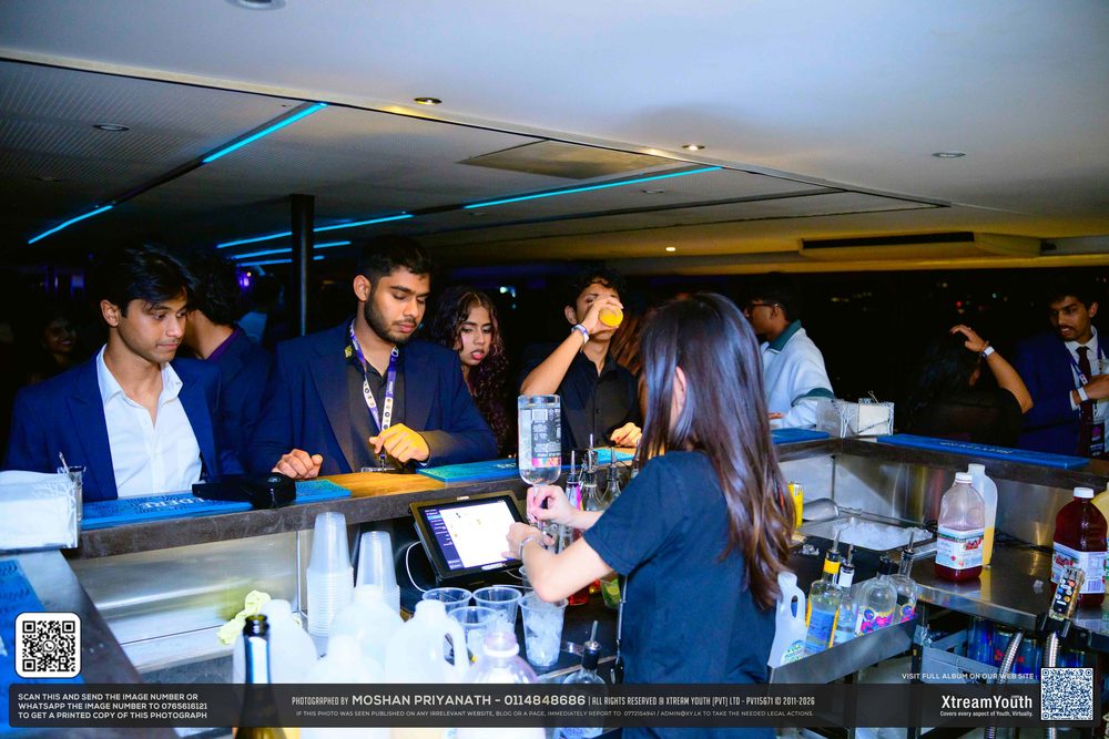 The bar mid service, guests lined along it waiting on drinks.