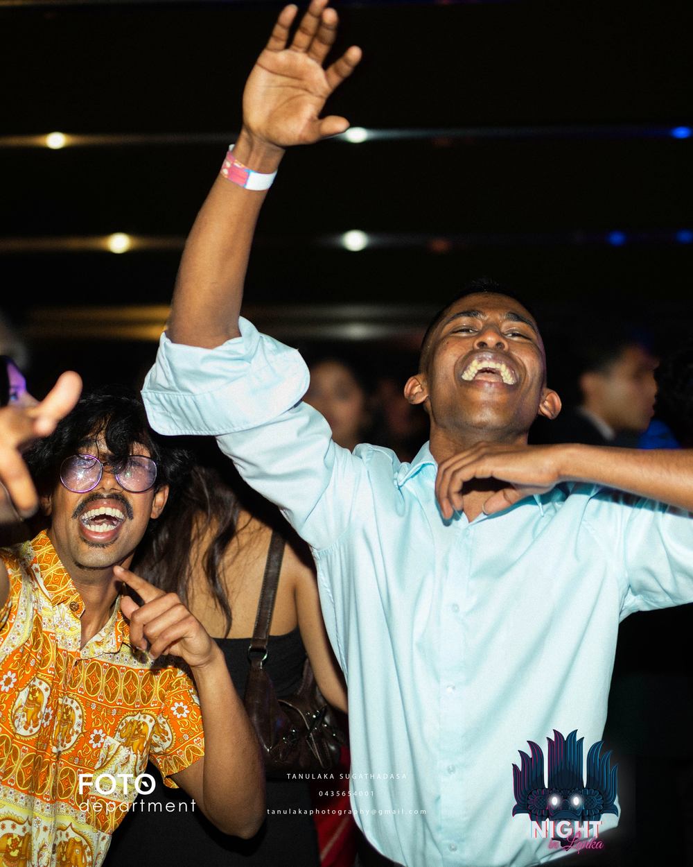A guest with one arm thrown up mid song, grinning, crowd behind.